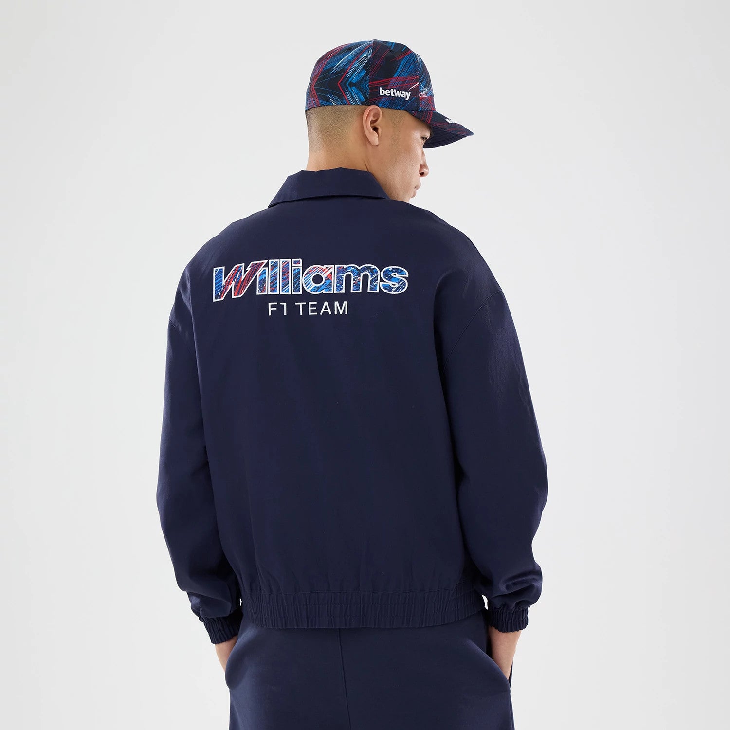 The model is wearing this Williams GB Race Special Collared Jacket in navy. 2