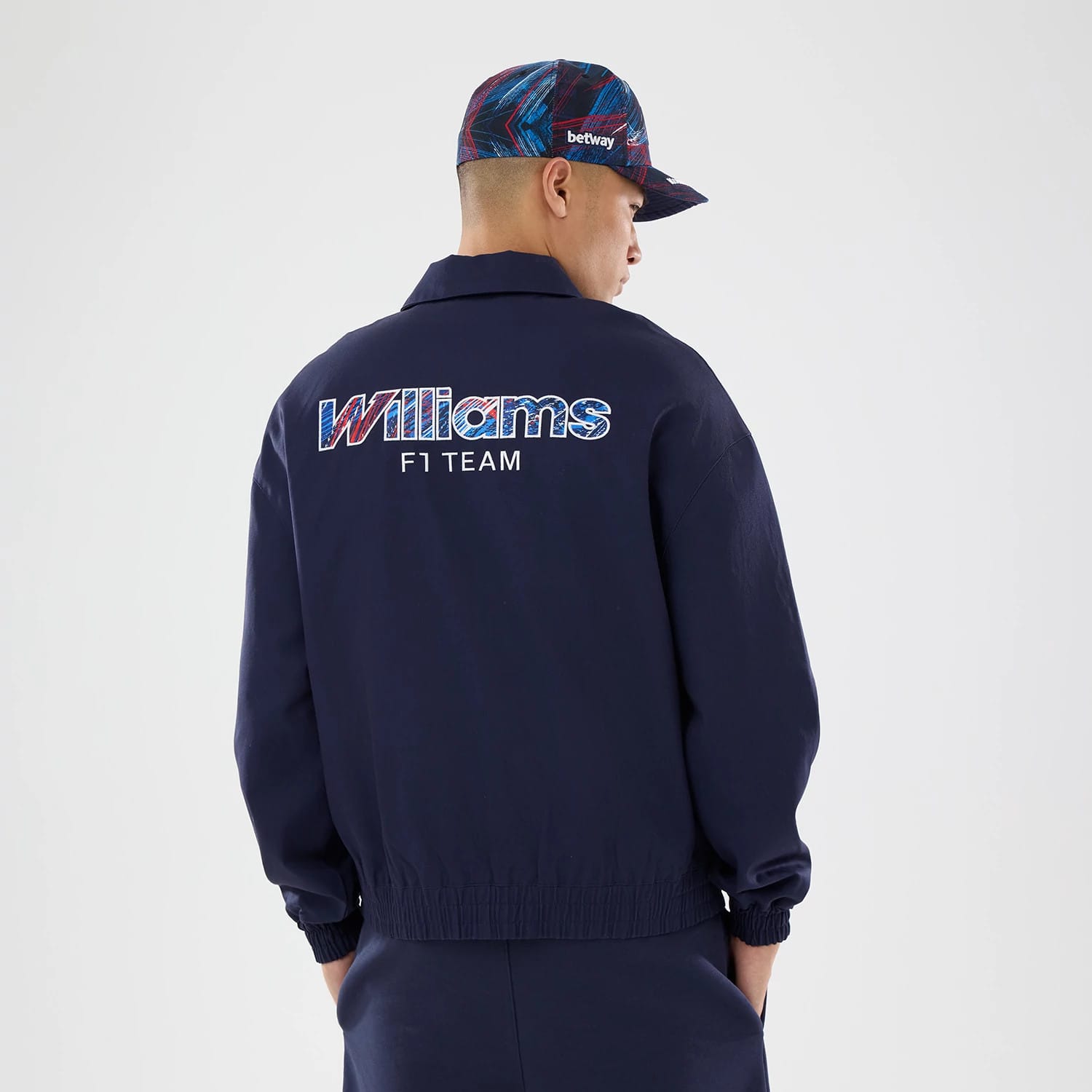 The model is wearing this Williams GB Race Special Collared Jacket in navy. 2