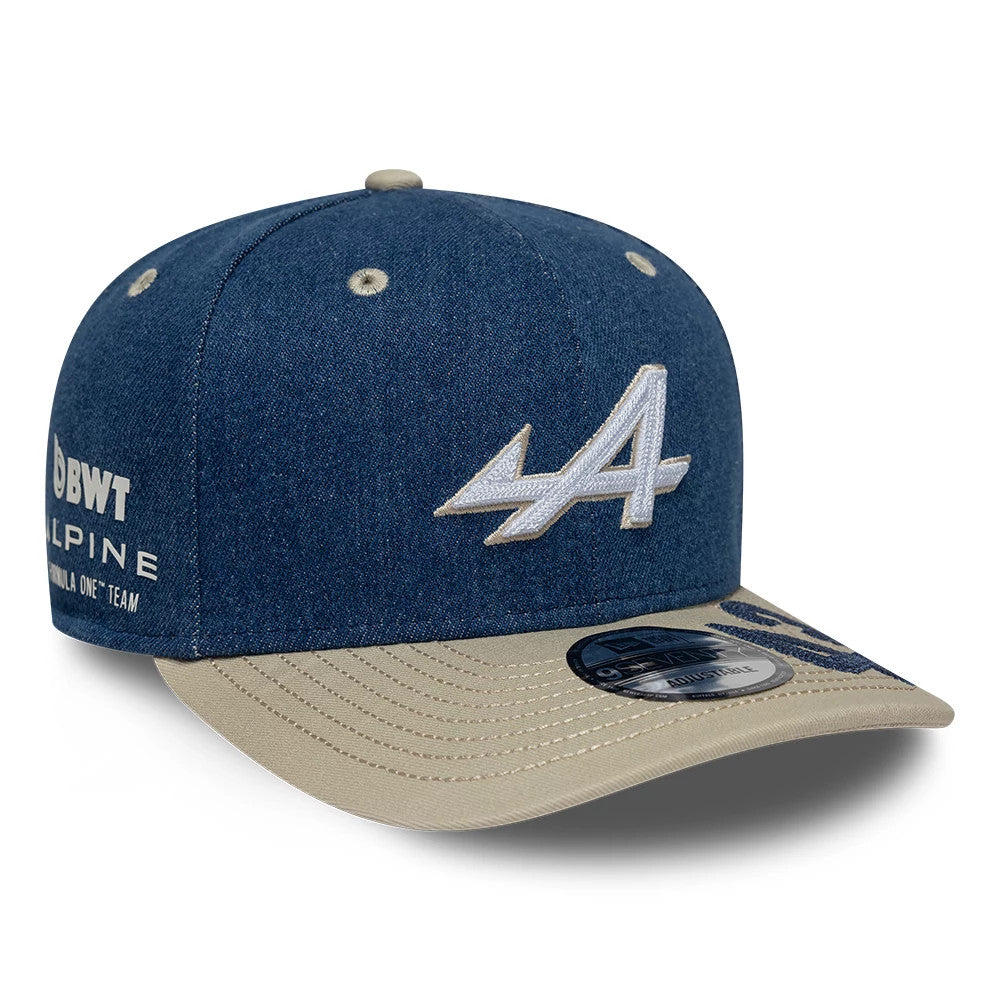 Alpine Racing Austin Race Special Franco Colapinto Navy New Era 9SEVENTY Stretch Snap Adjustable Cap, three-quarter view showing the white embroidered A logo on the front panel, contrasting beige visor and BWT Alpine logo on the left side.