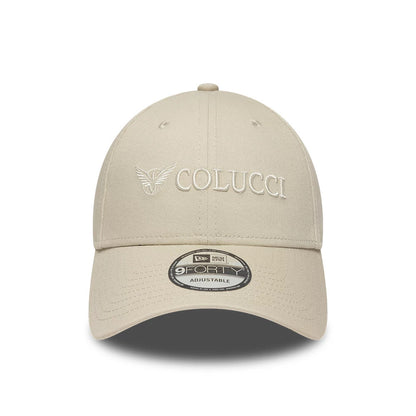 Colucci X New Era Light Beige 9FORTY Adjustable Cap, front view showing the raised embroidered Colucci logo with an eagle graphic on the front panel, a curved visor and a 9FORTY size sticker on the visor.