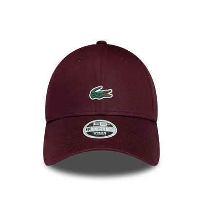 Pictured is this Womens Lacoste X New Era 9FORTY cap in dark purple. 2
