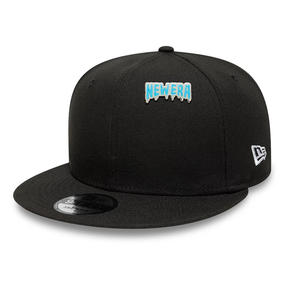 Pictured is this New Era Drip Script Pin Badge in silver. 2