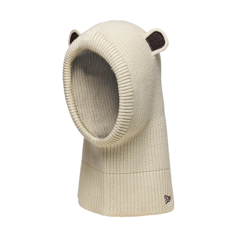 Child New Era Bear Light Beige Balaclava Hat, three-quarter view showing knit fabrication with cute bear ears on top, a wide ribbed opening for the face, and a small embroidered New Era flag logo near the bottom edge.