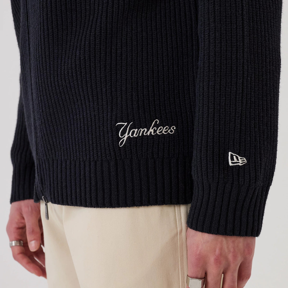 The model is wearing this MLB New York Yankees 2 Way Zip Cardigan in navy. 6