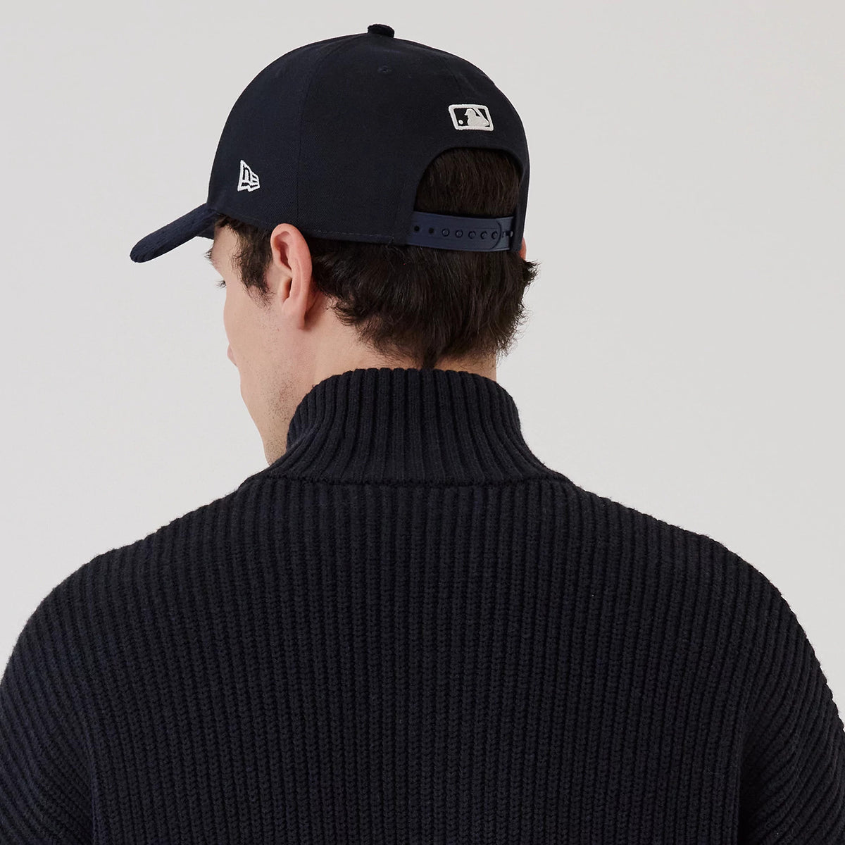 The model is wearing this MLB New York Yankees 2 Way Zip Cardigan in navy. 7