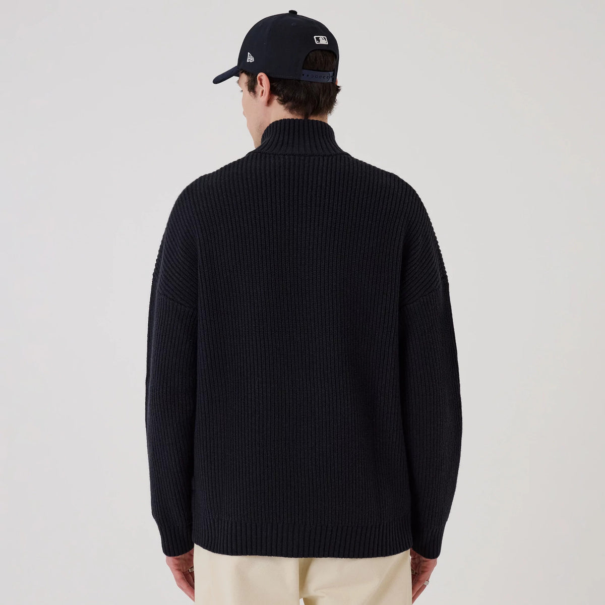 The model is wearing this MLB New York Yankees 2 Way Zip Cardigan in navy. 2
