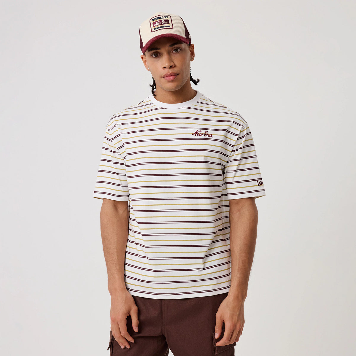 The model is wearing this New Era Stripe T-Shirt in white. 3