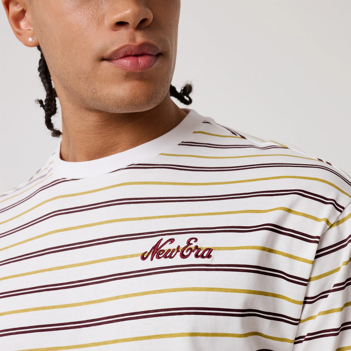 The model is wearing this New Era Stripe T-Shirt in white. 5
