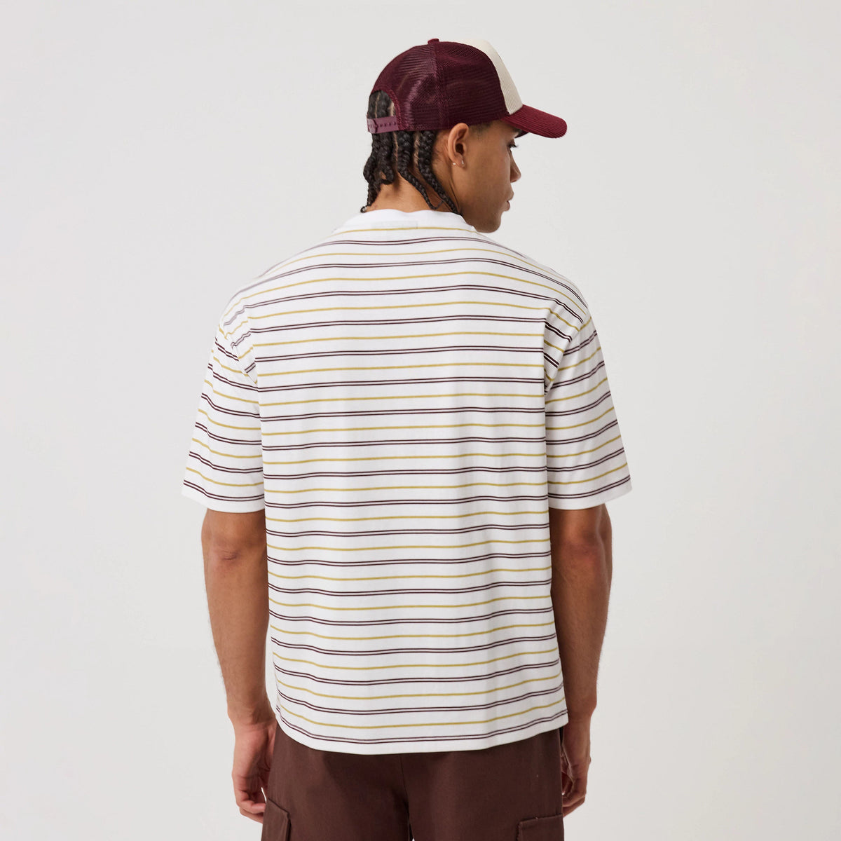 The model is wearing this New Era Stripe T-Shirt in white. 2