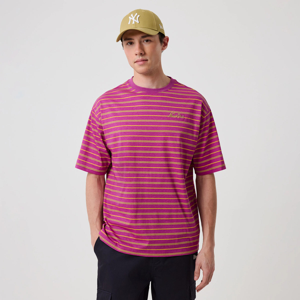 The model is wearing this New Era Stripe T-Shirt in bright purple. 3