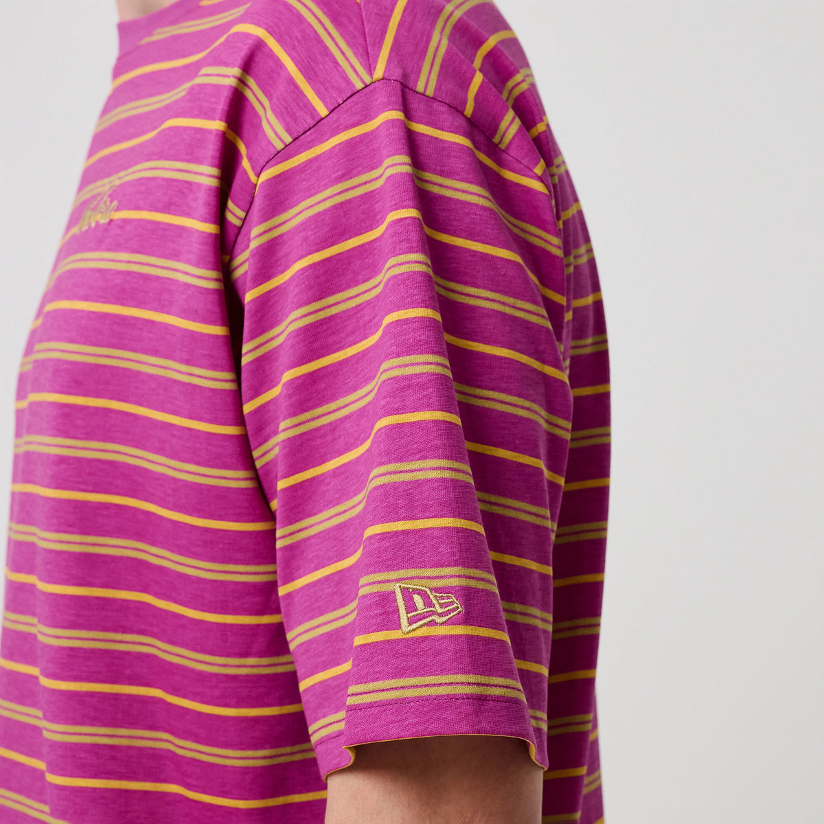 The model is wearing this New Era Stripe T-Shirt in bright purple. 7
