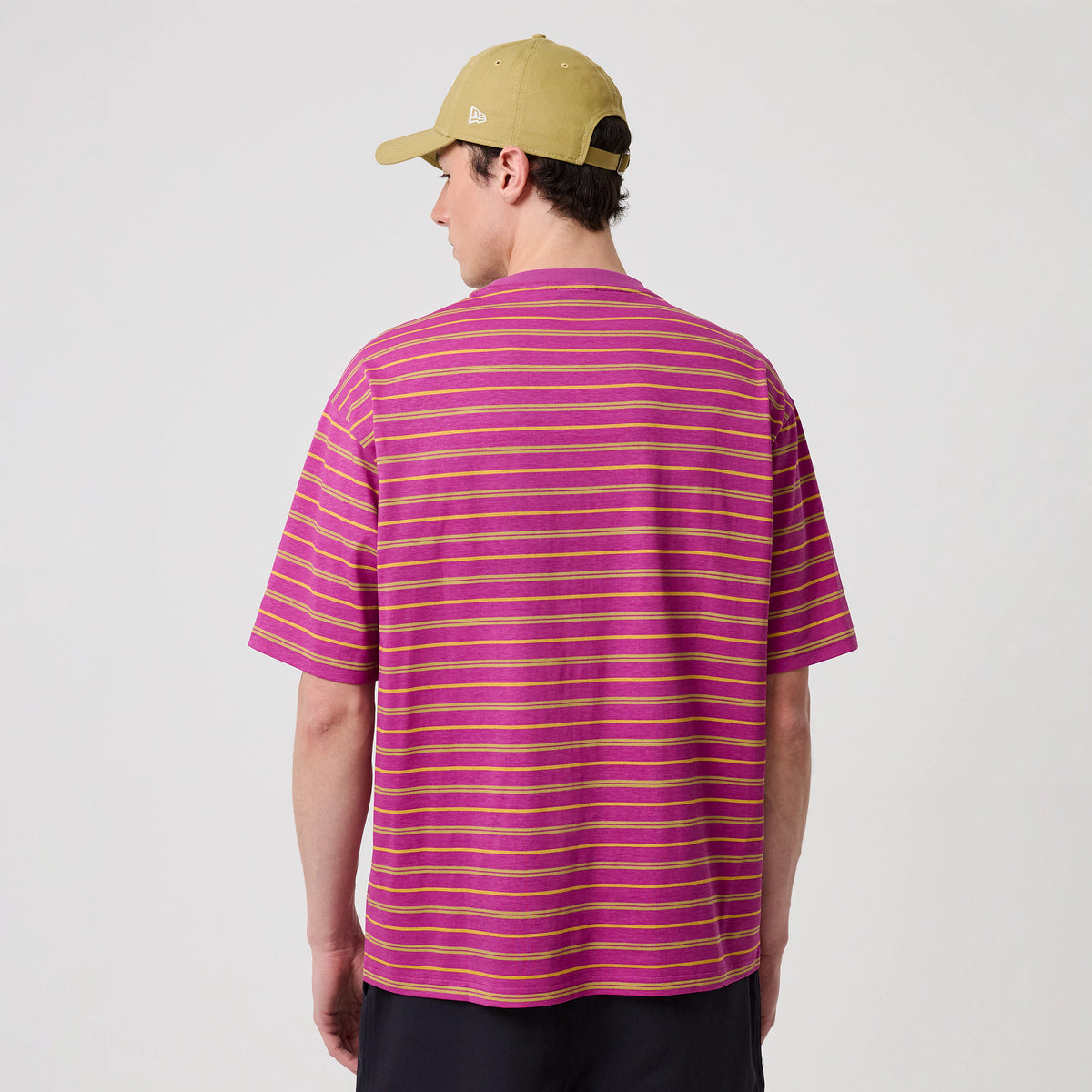 The model is wearing this New Era Stripe T-Shirt in bright purple. 2