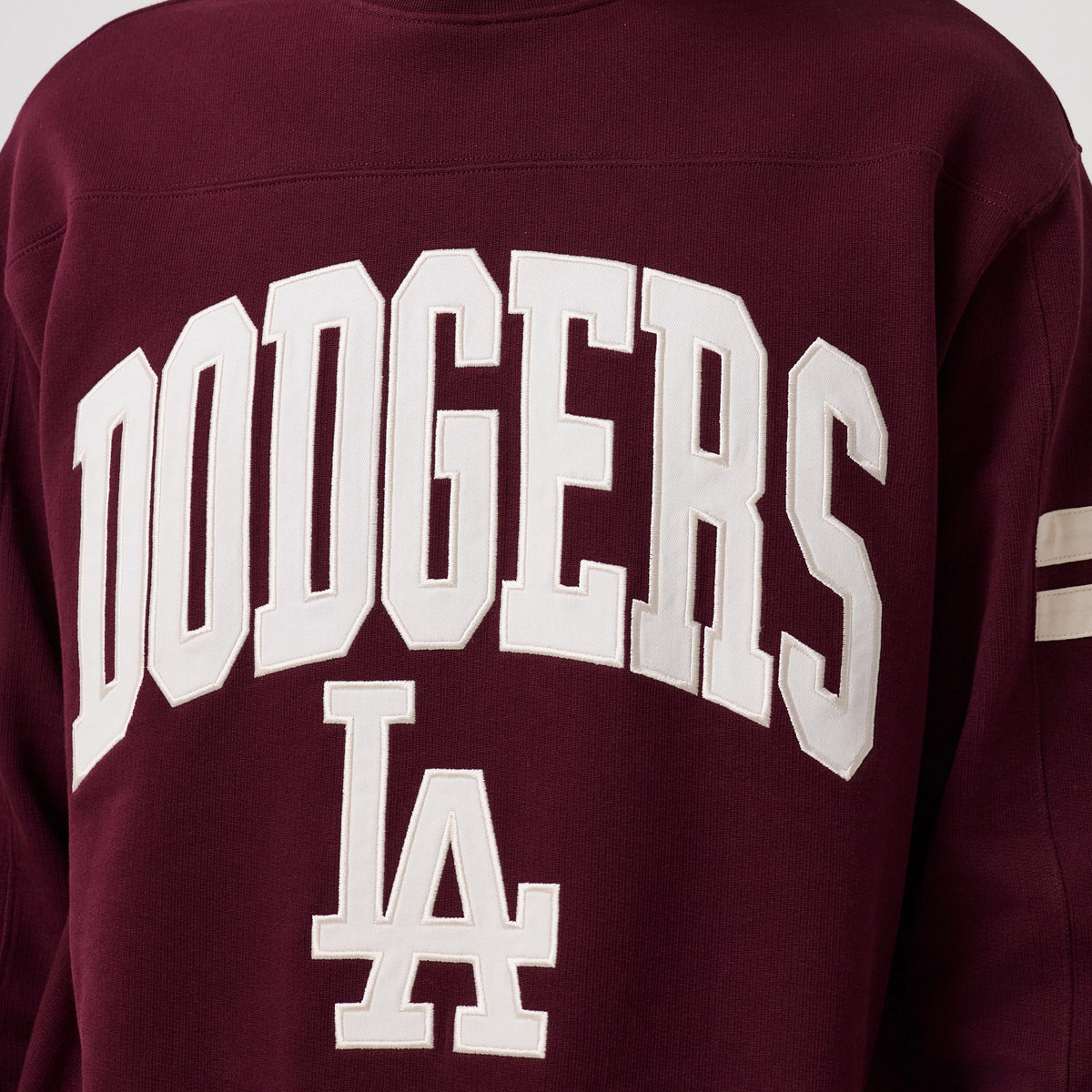 The model is wearing this MLB Arch Graphic LA Dodgers Crew Neck Sweater in dark purple. 5
