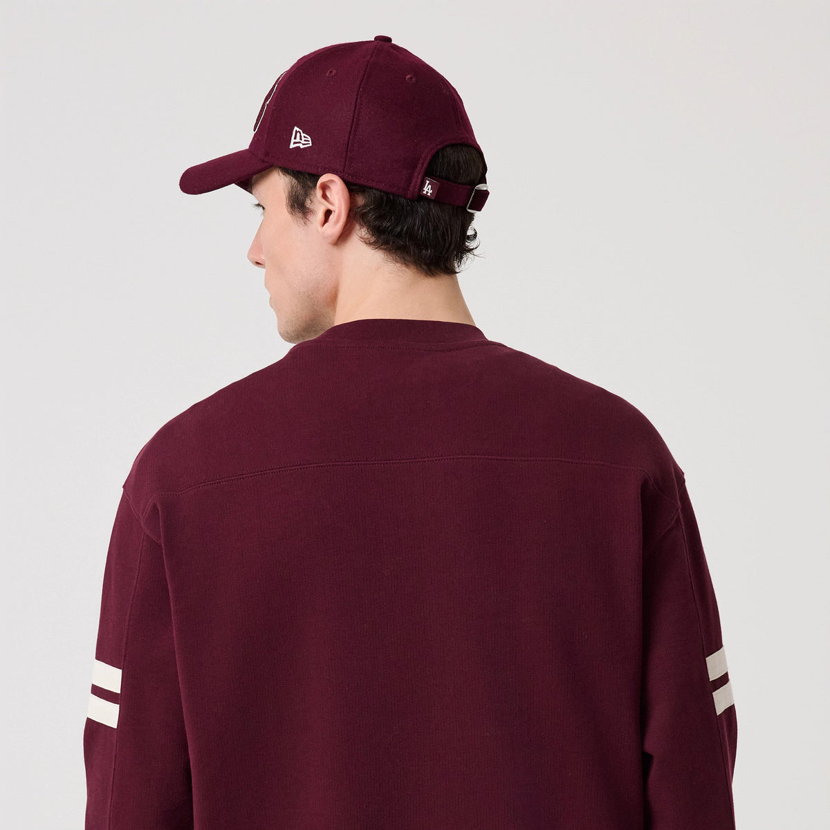 The model is wearing this MLB Arch Graphic LA Dodgers Crew Neck Sweater in dark purple. 8