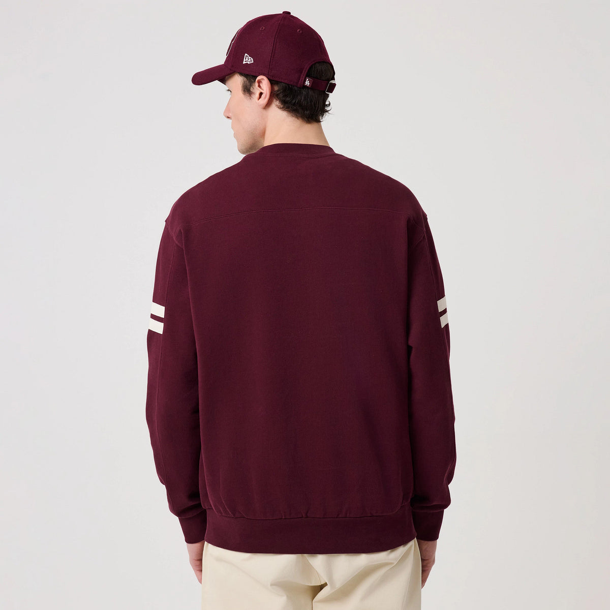 The model is wearing this MLB Arch Graphic LA Dodgers Crew Neck Sweater in dark purple. 2