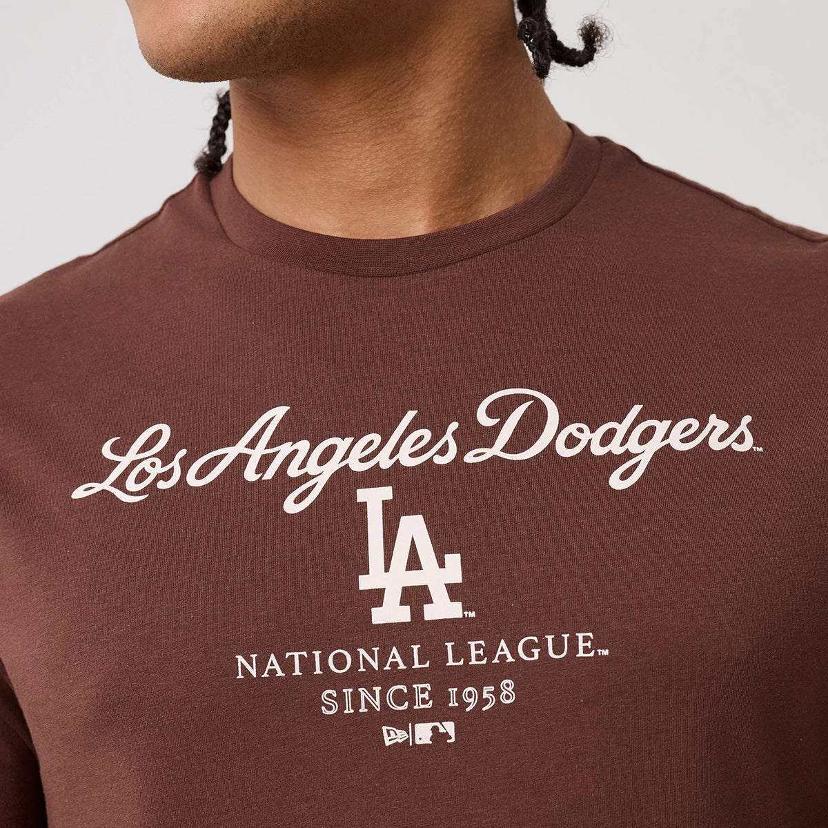 New Era LA Dodgers MLB Linear Brown T-Shirt, front view showing white embroidered Los Angeles Dodgers script across the chest, an LA logo centred beneath, with National League, Since 1958, and New Era logos creating a classic look.