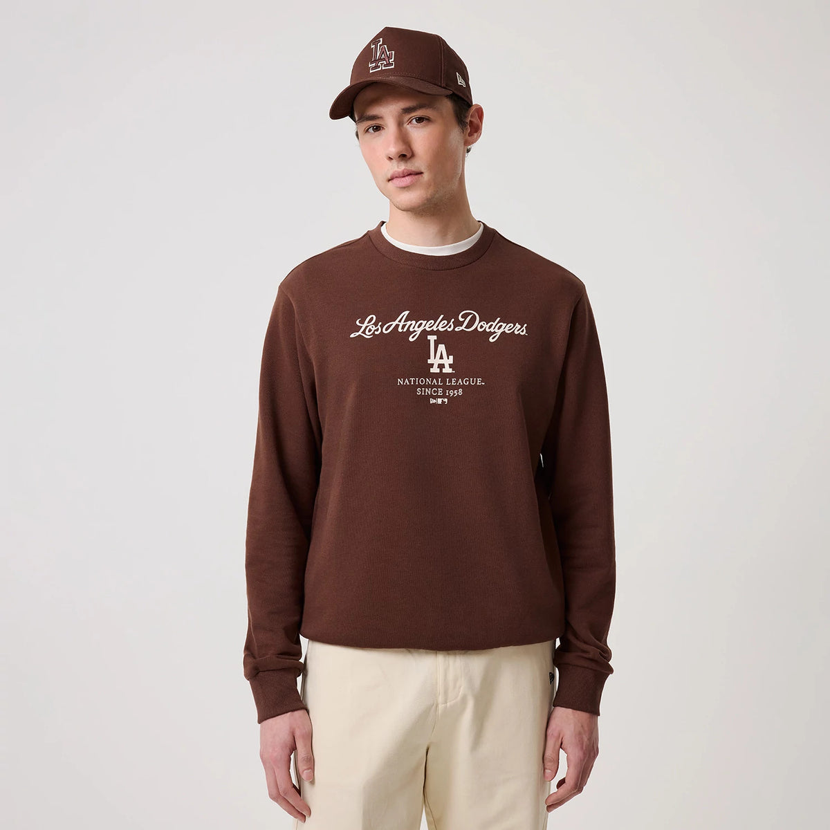 The model is wearing this MLB Linear LA Dodgers Crew Neck Sweater in brown. 3