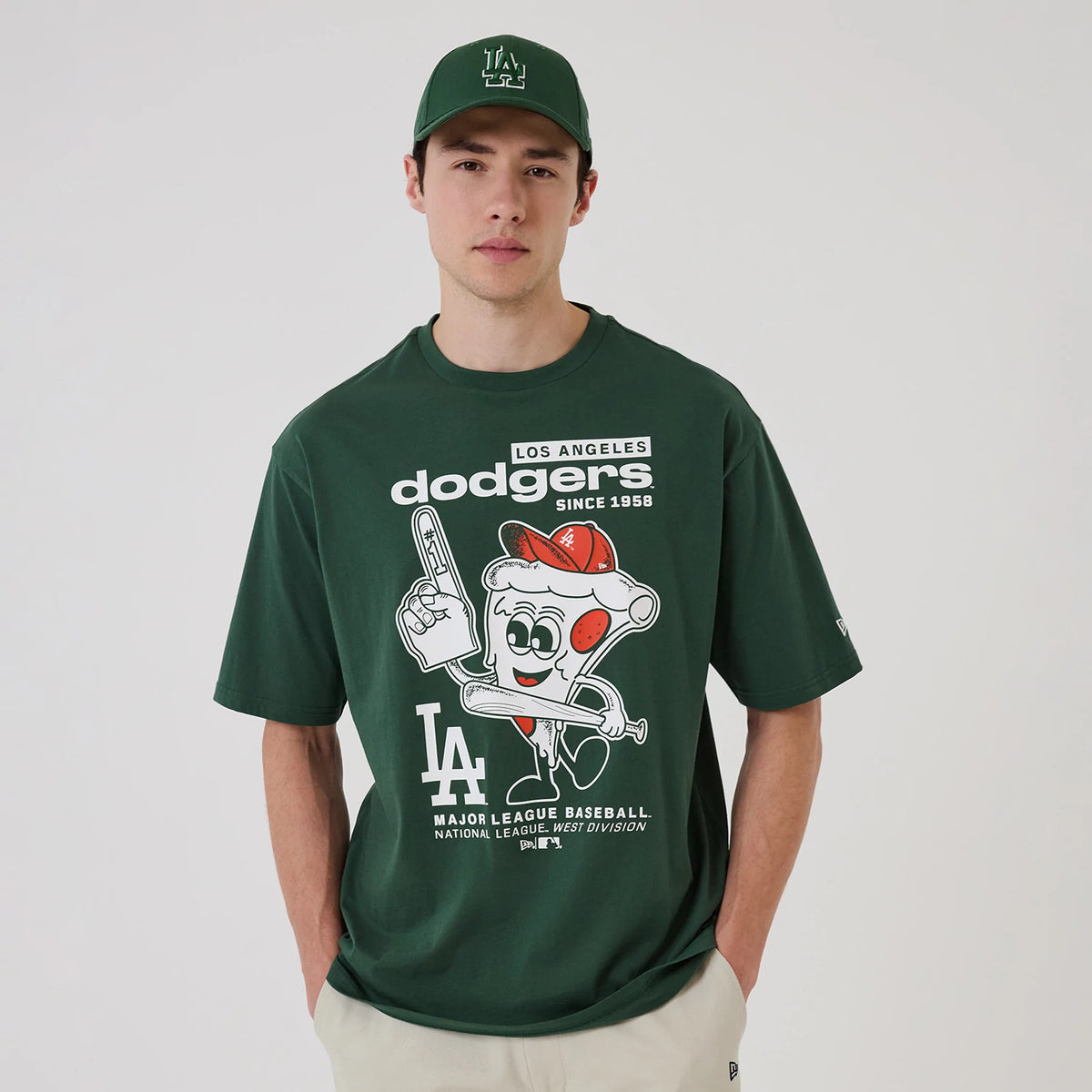 The model is wearing this MLB Food Graphic LA Dodgers Oversized T-Shirt in dark green. 1