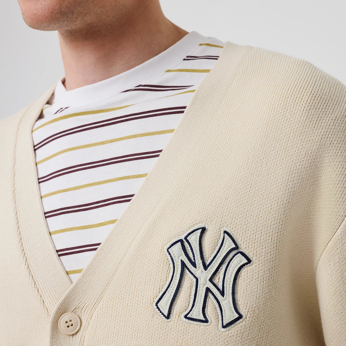 The model is wearing this MLB Knit New York Yankees Cardigan in light beige. 5