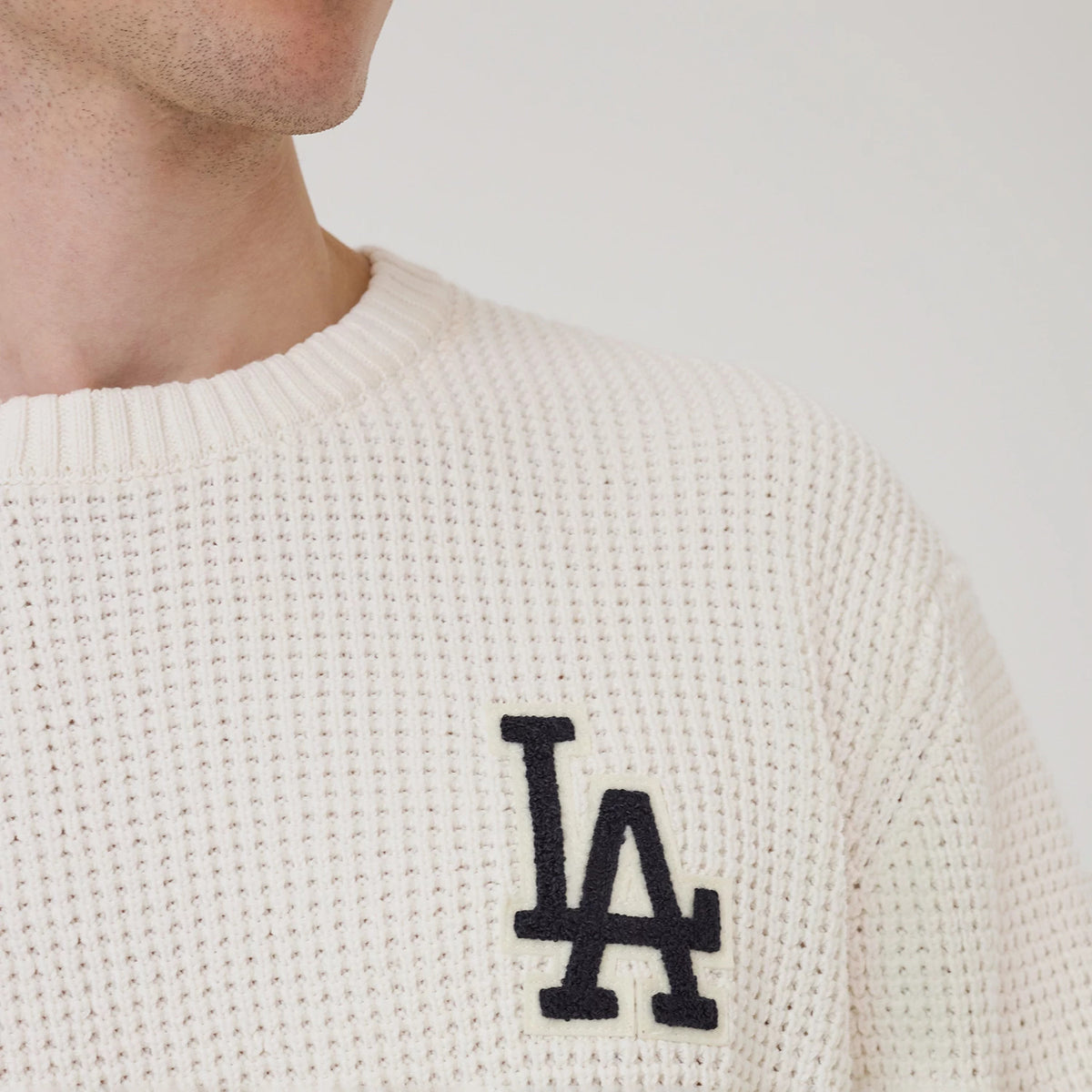 The model is wearing this MLB Waffle Knit LA Dodgers Crew Neck Sweater in open white. 4