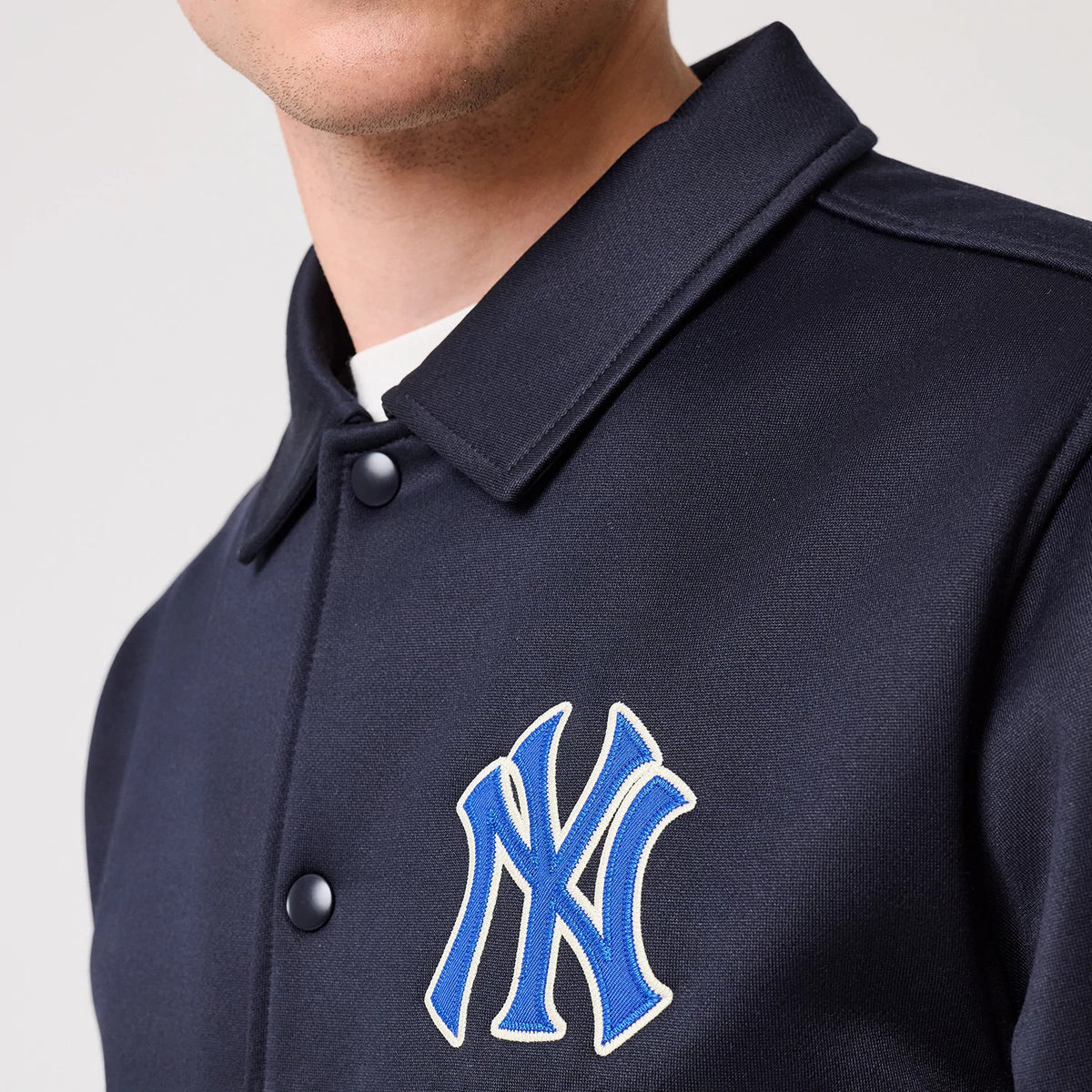 The model is wearing this MLB New York Yankees Collared Jacket in navy. 5