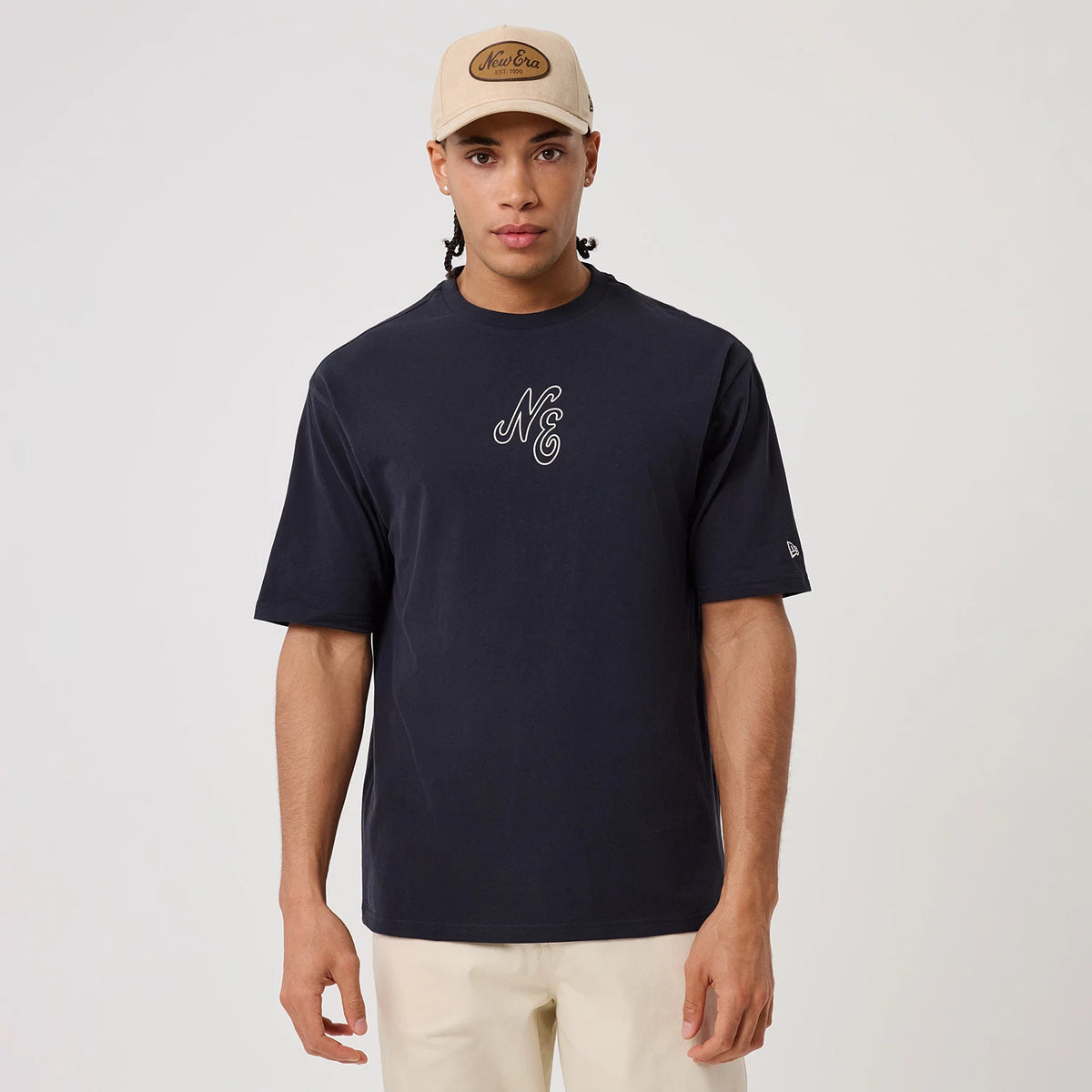 The model is wearing this New Era Crest Graphic Oversized T-Shirt in navy. 3