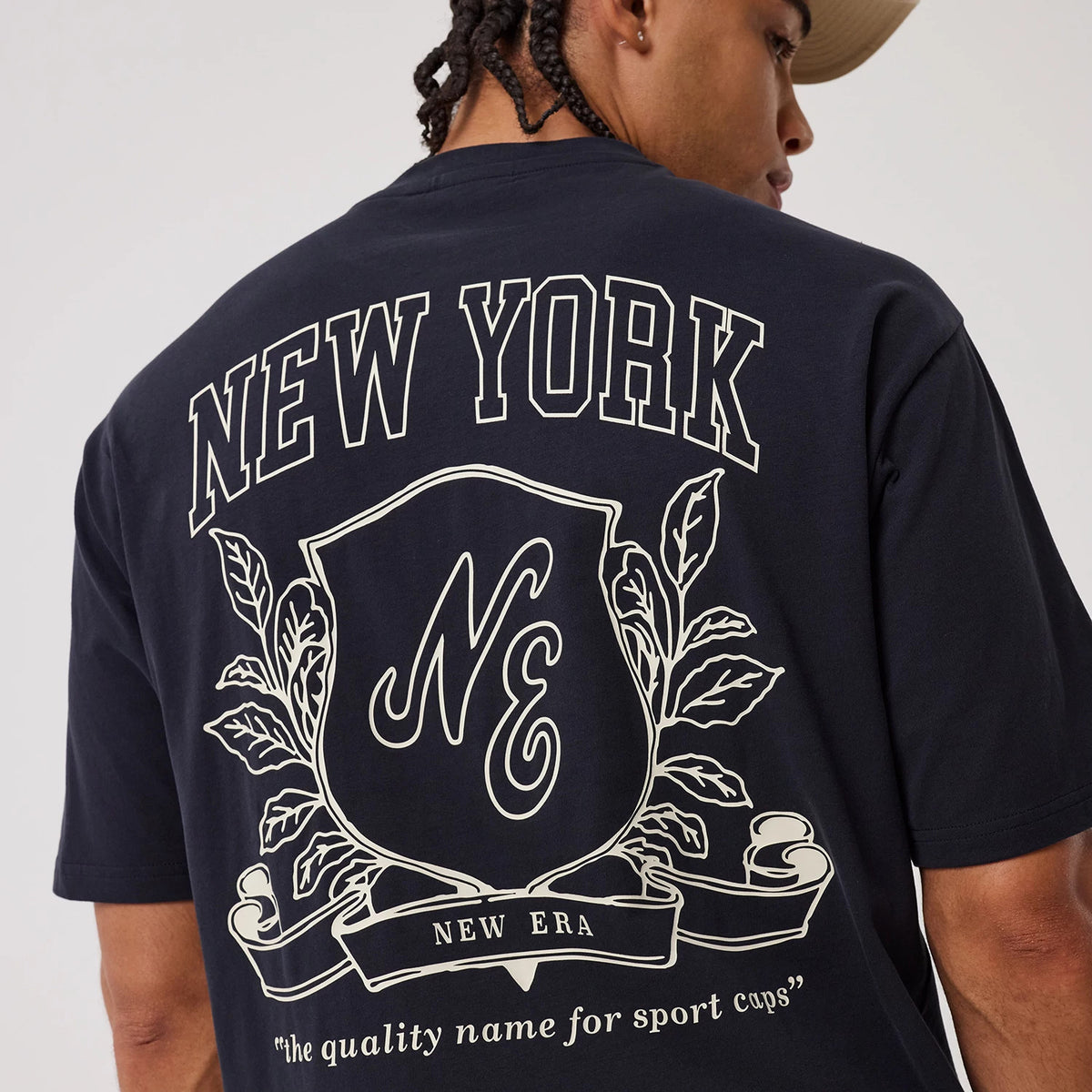 The model is wearing this New Era Crest Graphic Oversized T-Shirt in navy. 8
