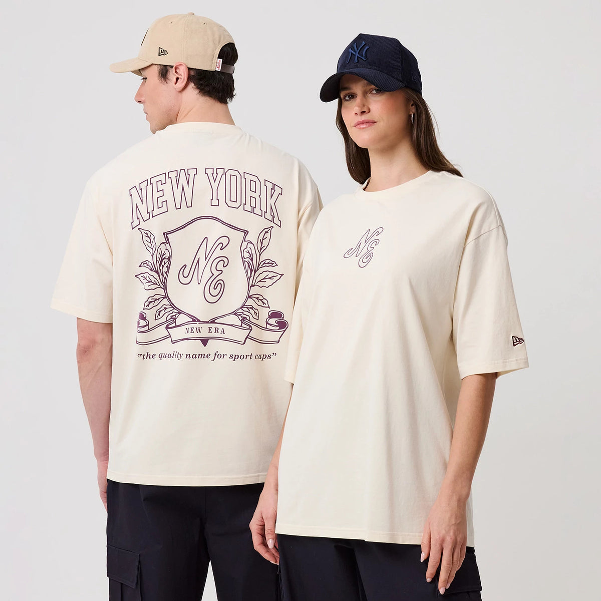 The model is wearing this New Era Crest Graphic Oversized T-Shirt in open white. 1
