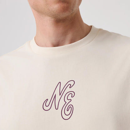 The model is wearing this New Era Crest Graphic Oversized T-Shirt in open white. 5