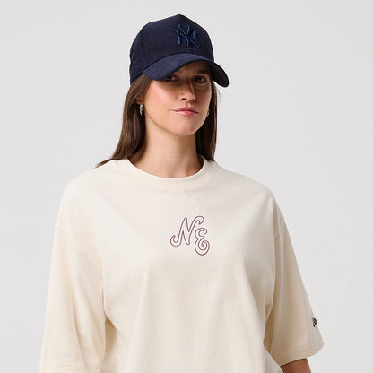 The model is wearing this New Era Crest Graphic Oversized T-Shirt in open white. 6