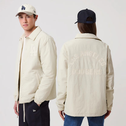 The model is wearing this MLB LA Dodgers Coach Jacket in light beige. 1