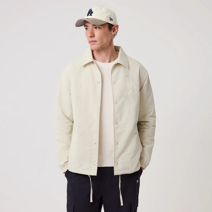The model is wearing this MLB LA Dodgers Coach Jacket in light beige. 3
