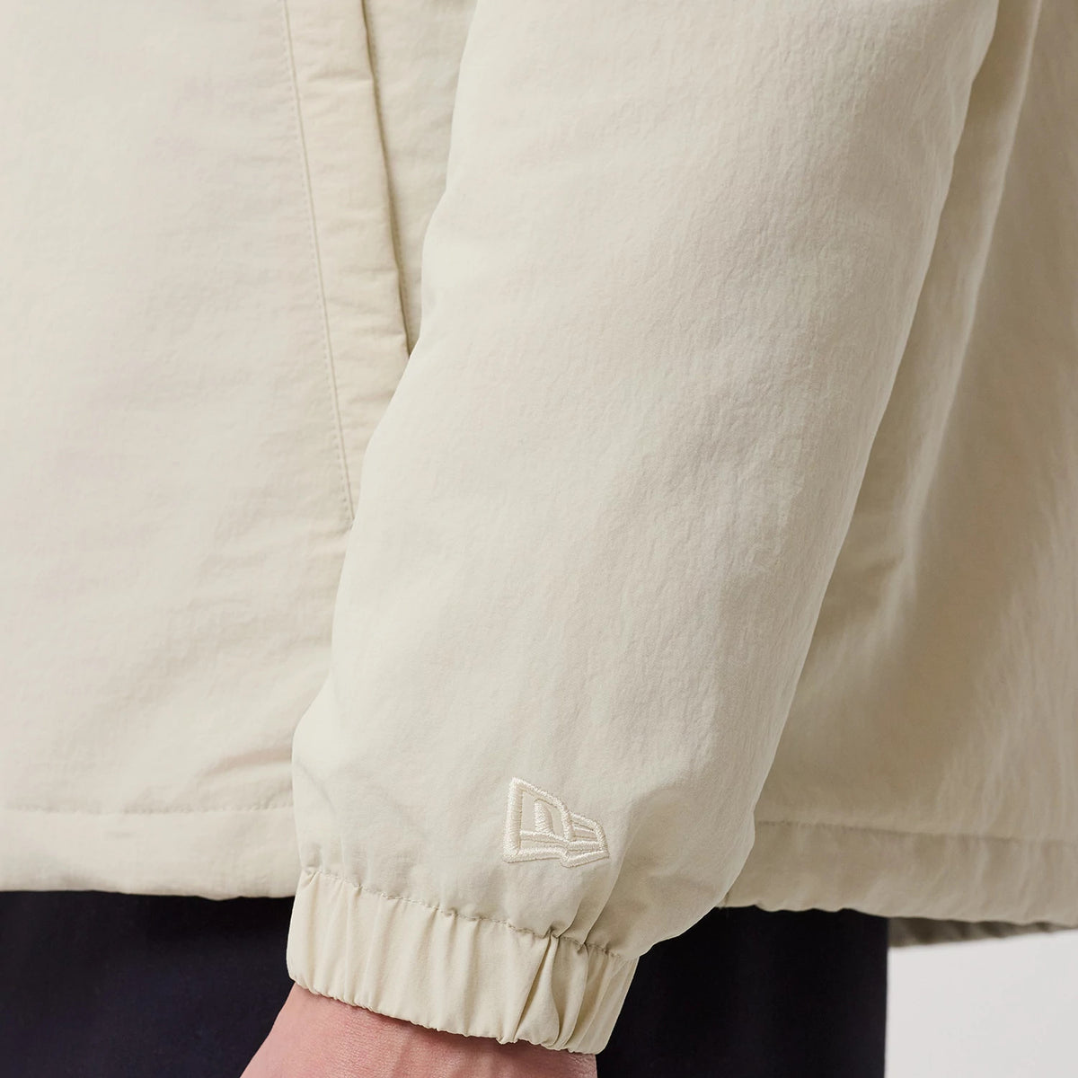 The model is wearing this MLB LA Dodgers Coach Jacket in light beige. 7