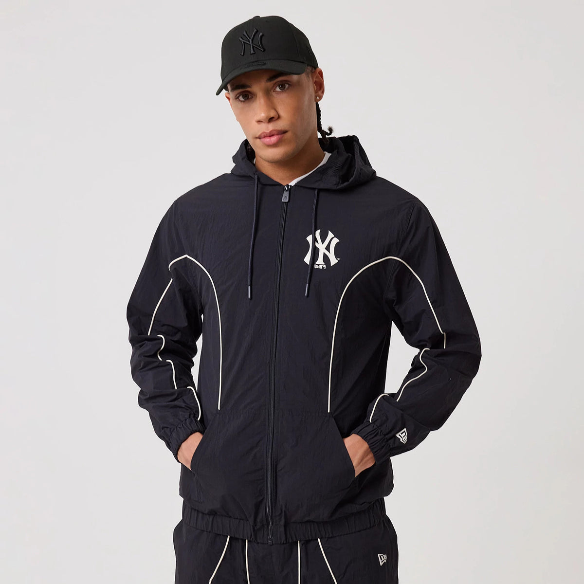The model is wearing this MLB Piping New York Yankees Track Jacket in navy. 3