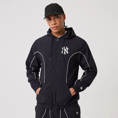 The model is wearing this MLB Piping New York Yankees Track Jacket in navy. 3