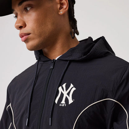 The model is wearing this MLB Piping New York Yankees Track Jacket in navy. 5