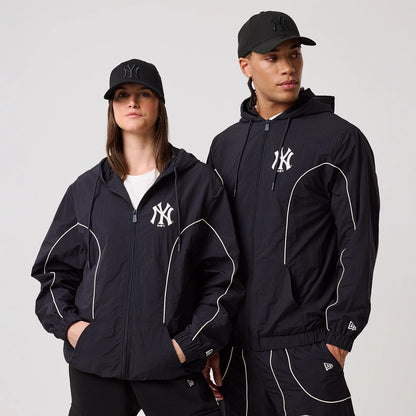 The model is wearing this MLB Piping New York Yankees Track Jacket in navy. 1