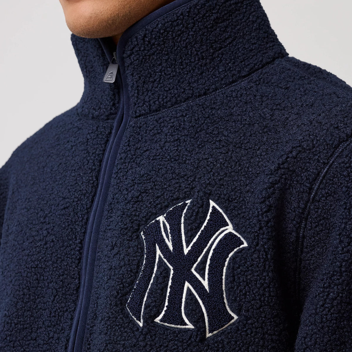 The model is wearing this MLB New York Yankees Sherpa Jacket in dark blue. 5
