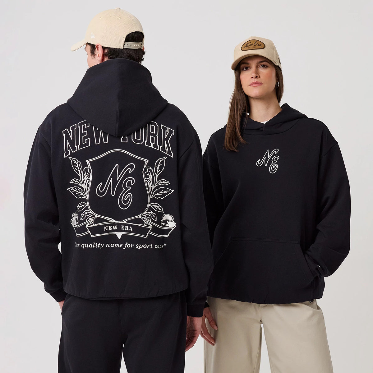 The model is wearing this New Era Crest Graphic Pullover Hoodie in navy. 1