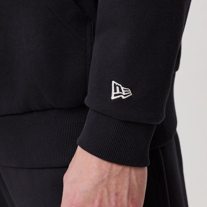 The model is wearing this New Era Crest Graphic Pullover Hoodie in navy. 7