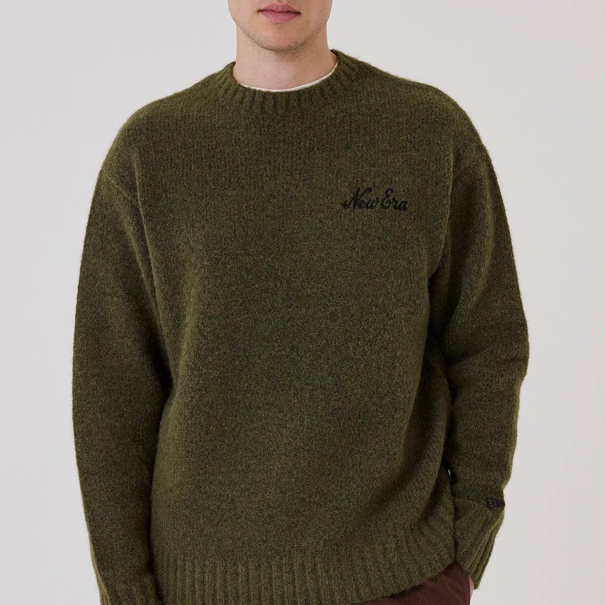 The model is wearing this New Era Simple Knit Knitted Sweater in green. 3