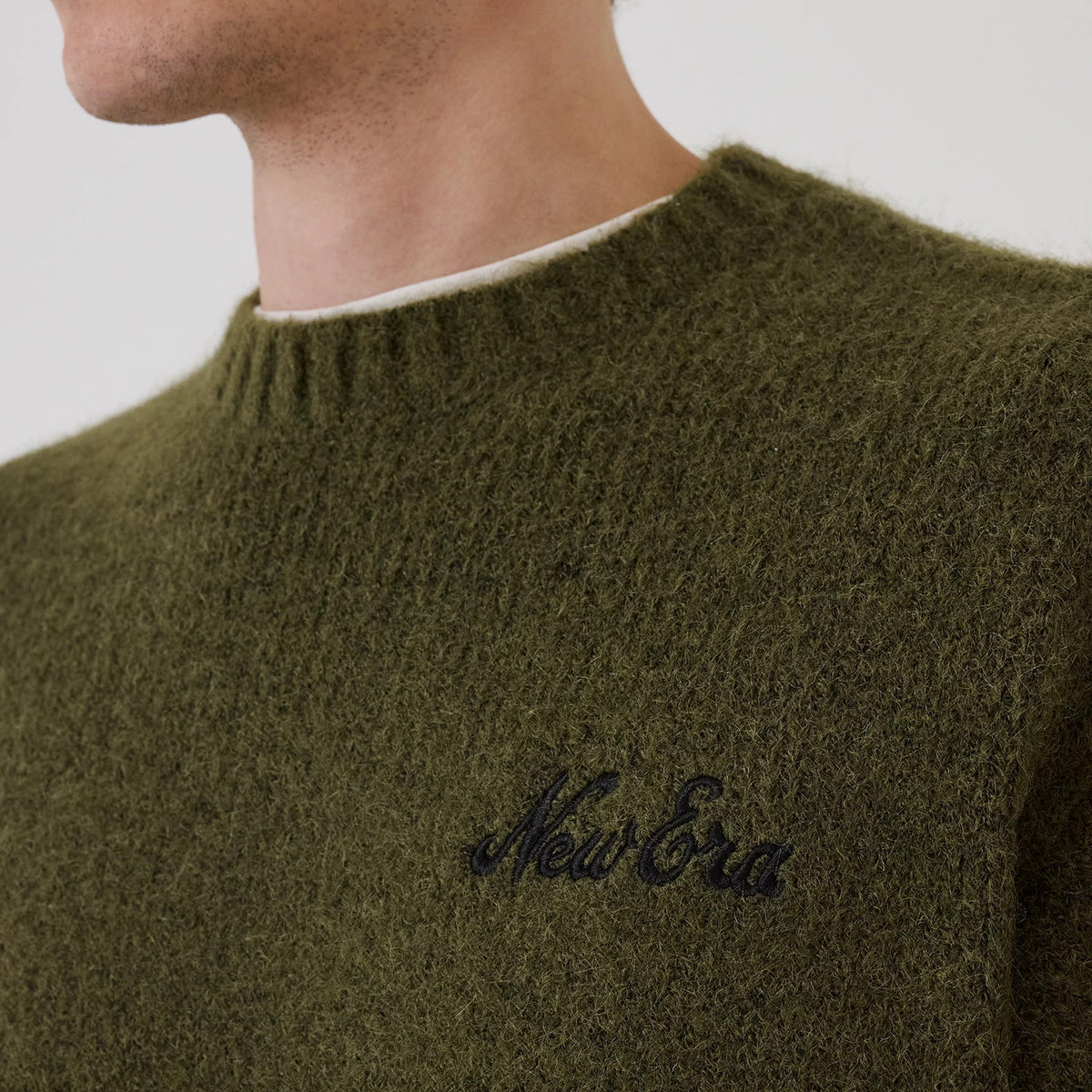 The model is wearing this New Era Simple Knit Knitted Sweater in green. 5