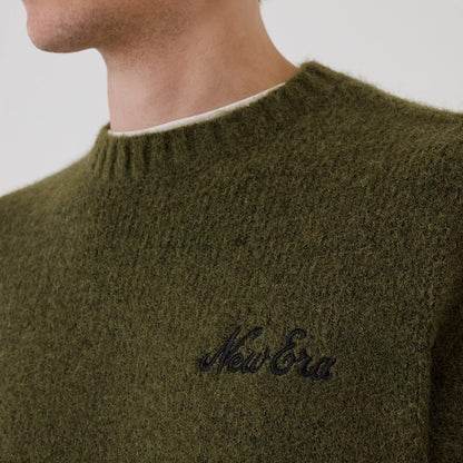 The model is wearing this New Era Simple Knit Knitted Sweater in green. 5