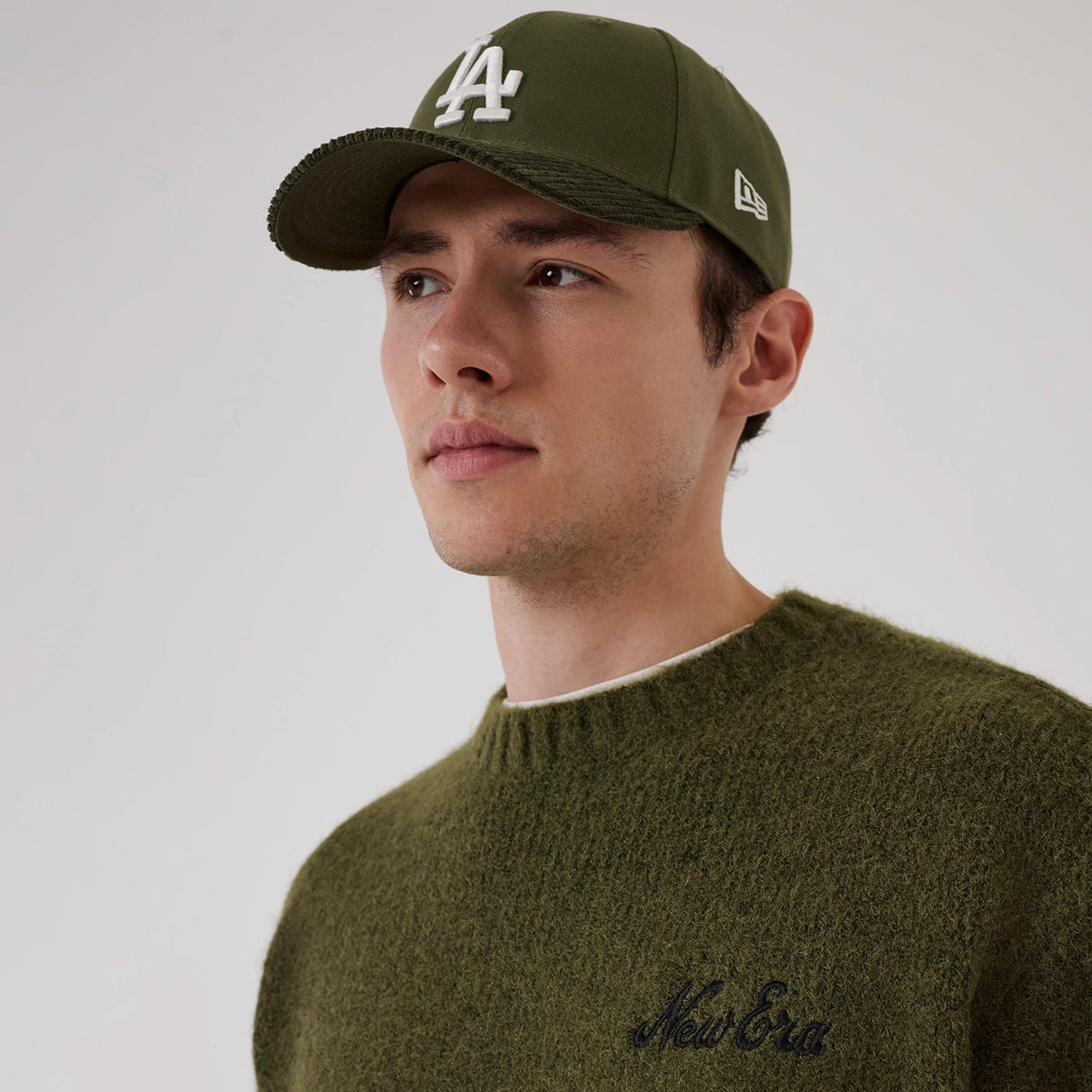 The model is wearing this New Era Simple Knit Knitted Sweater in green. 7