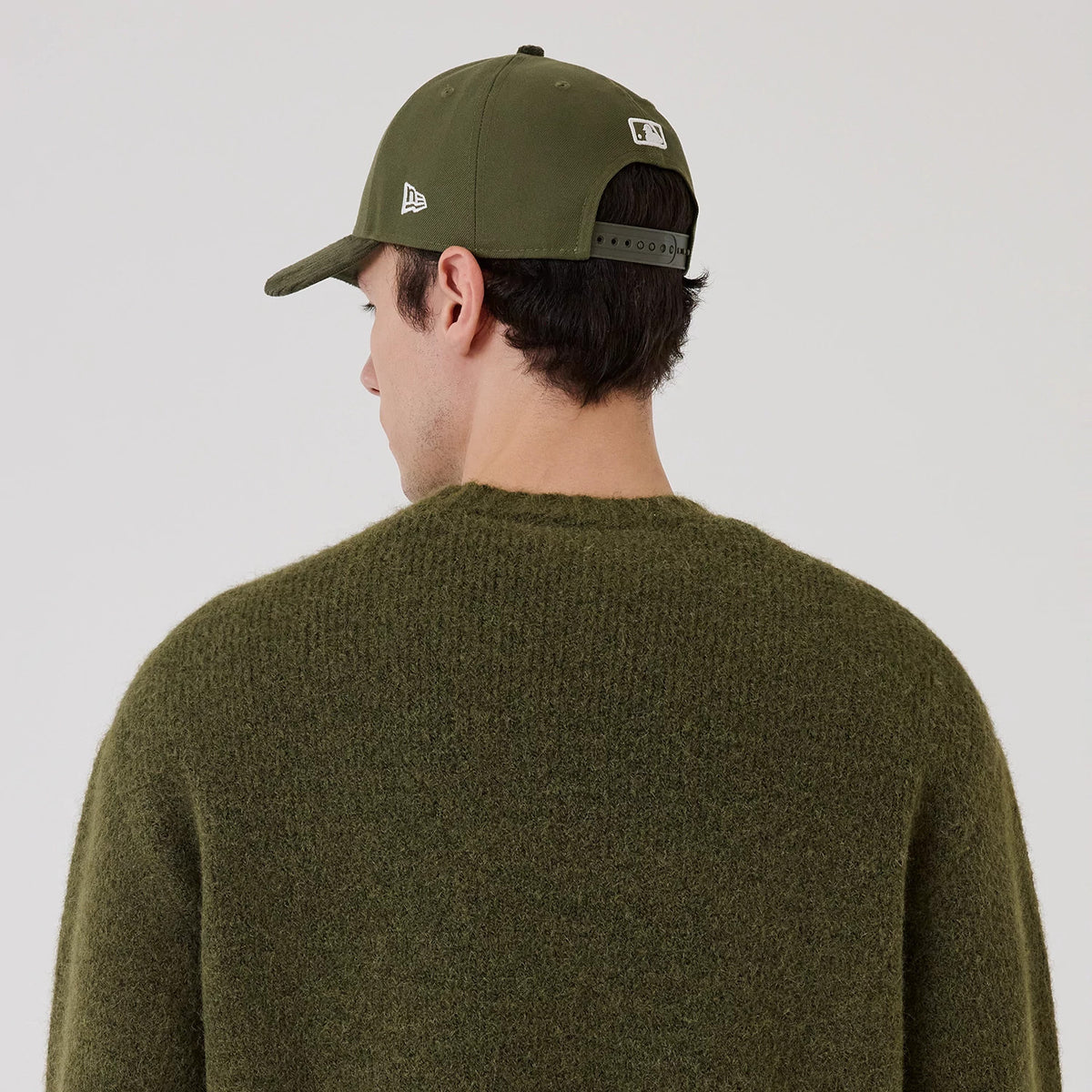 The model is wearing this New Era Simple Knit Knitted Sweater in green. 4