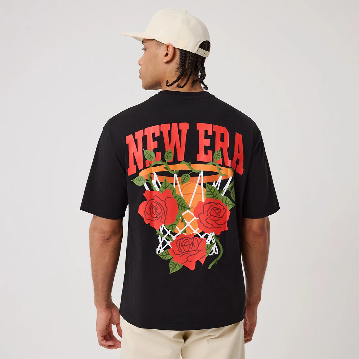 The model is wearing this New Era Floral Graphic T-Shirt in black. 2