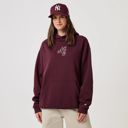 The model is wearing this New Era Crest Graphic Pullover Hoodie in dark purple. 4