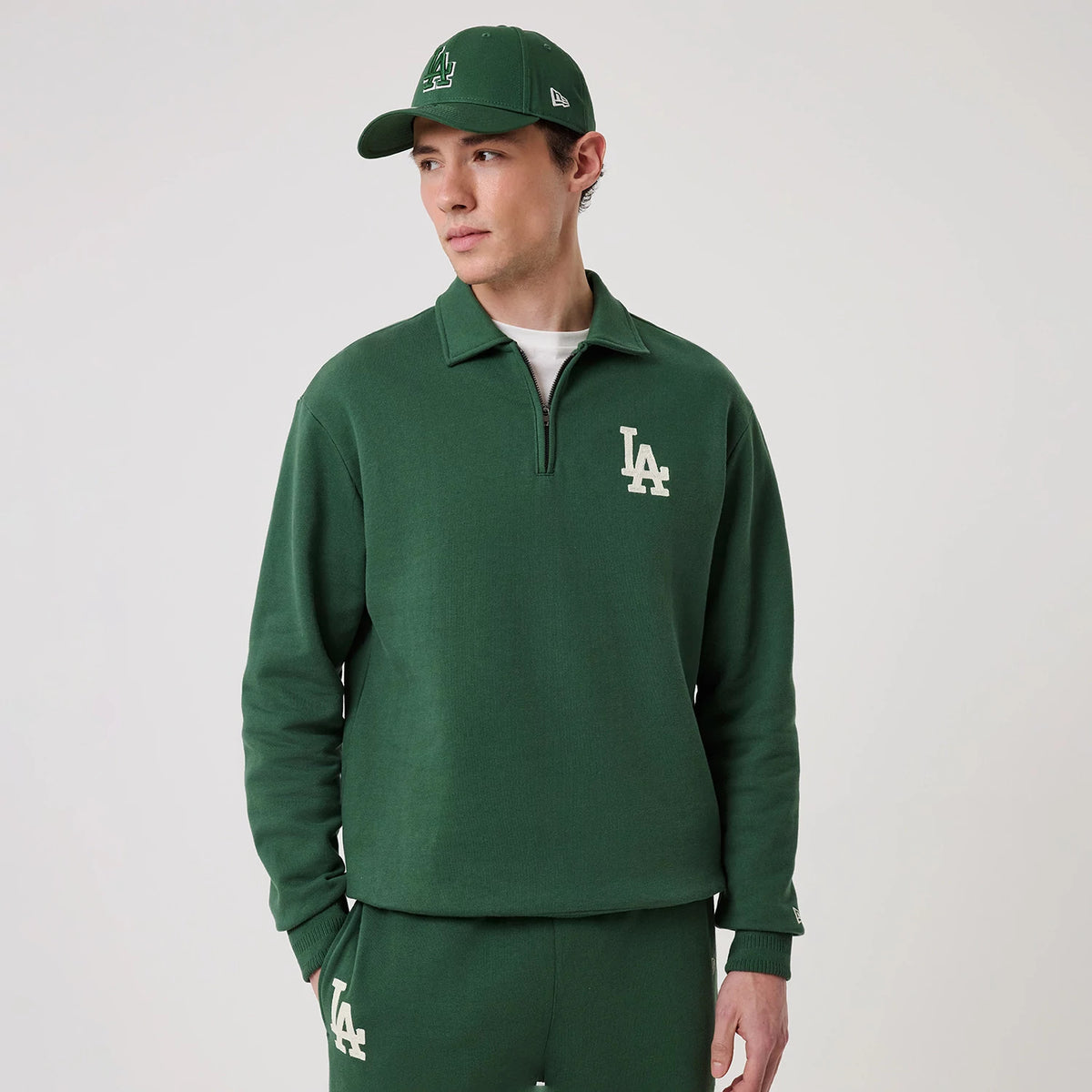 The model is wearing this MLB LA Dodgers 1/4 Zip Sweater in dark green. 3
