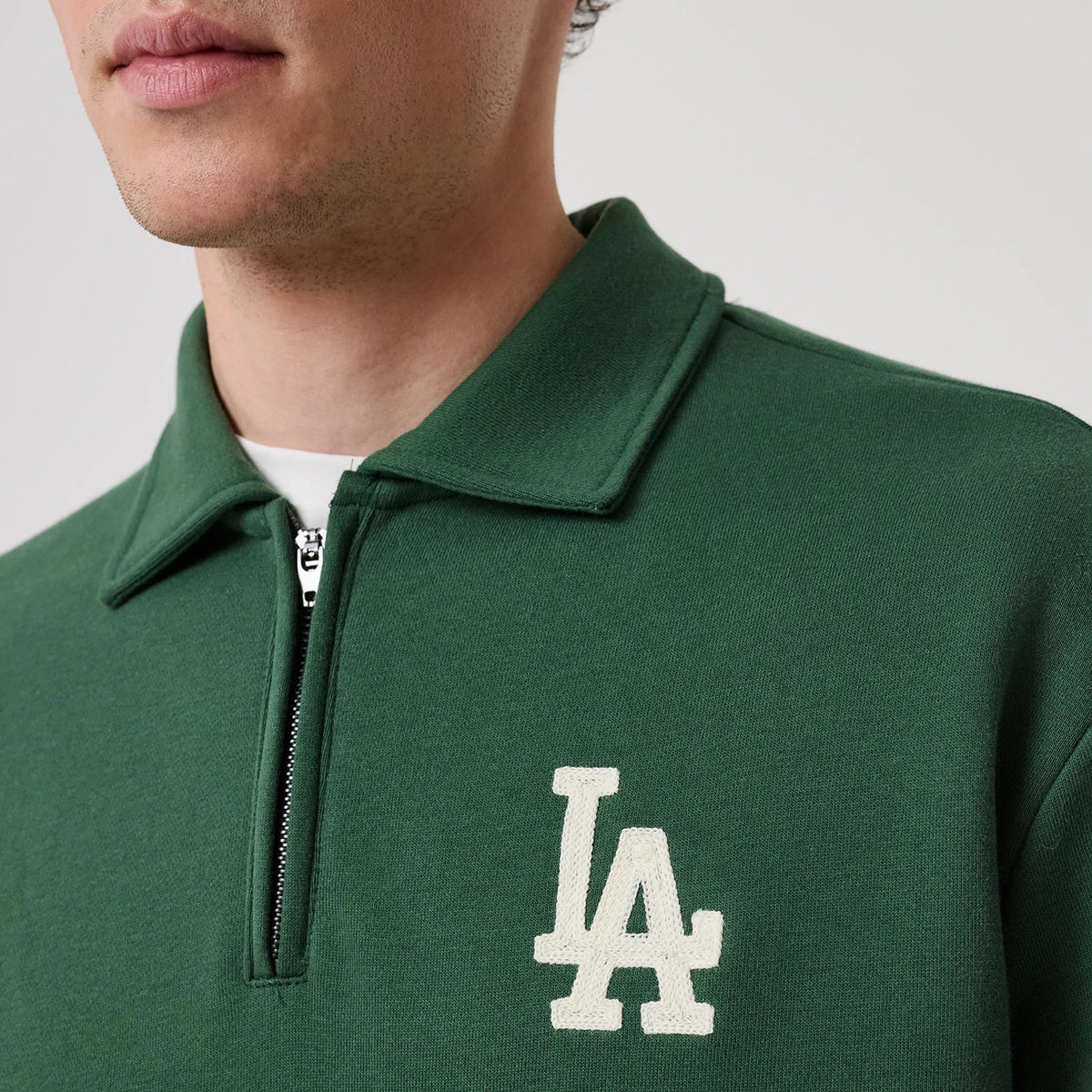 The model is wearing this MLB LA Dodgers 1/4 Zip Sweater in dark green. 5