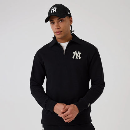 The model is wearing this MLB New York Yankees 1/4 Zip Sweater in black. 1